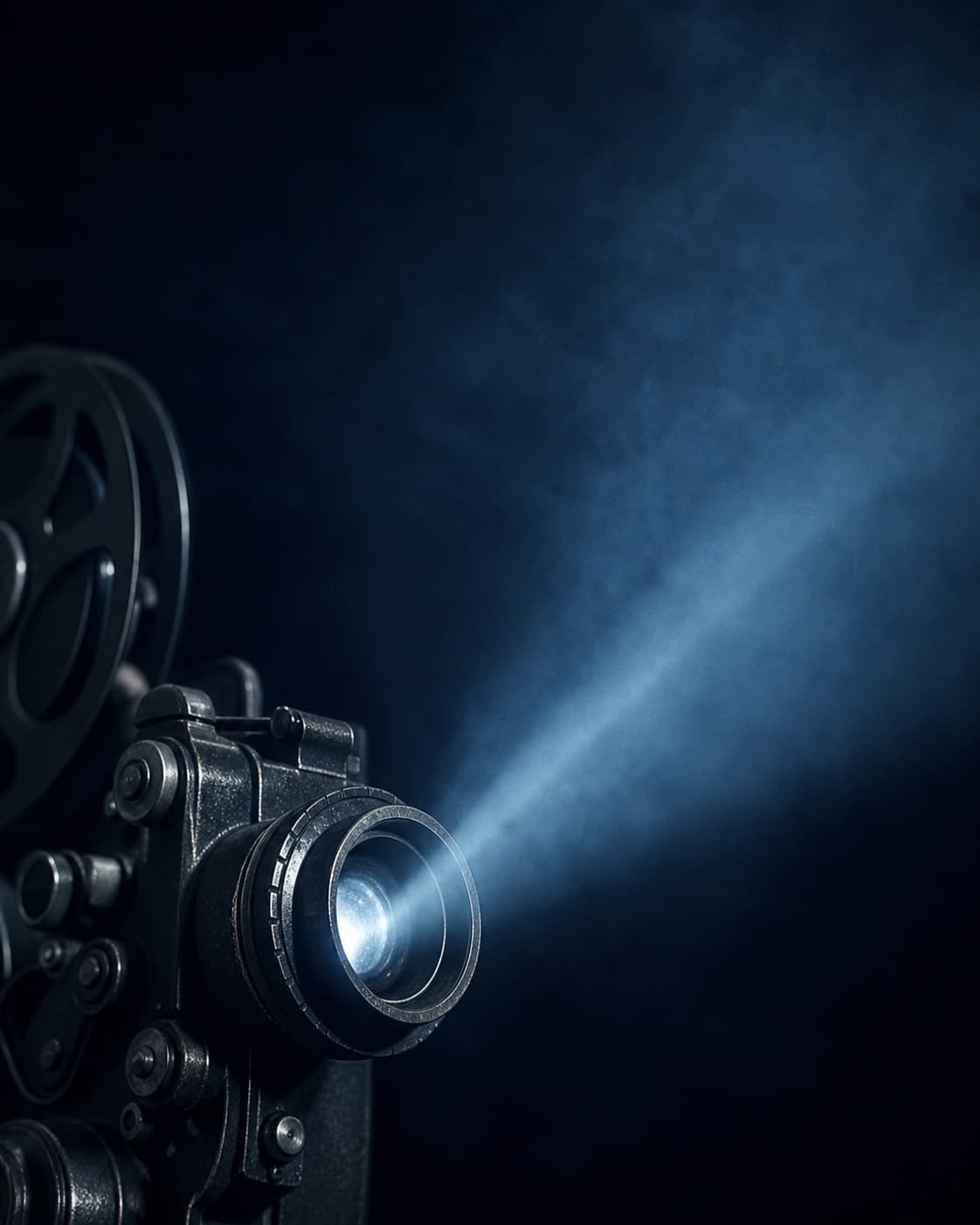 Vintage film projector casting a beam through midnight-blue haze