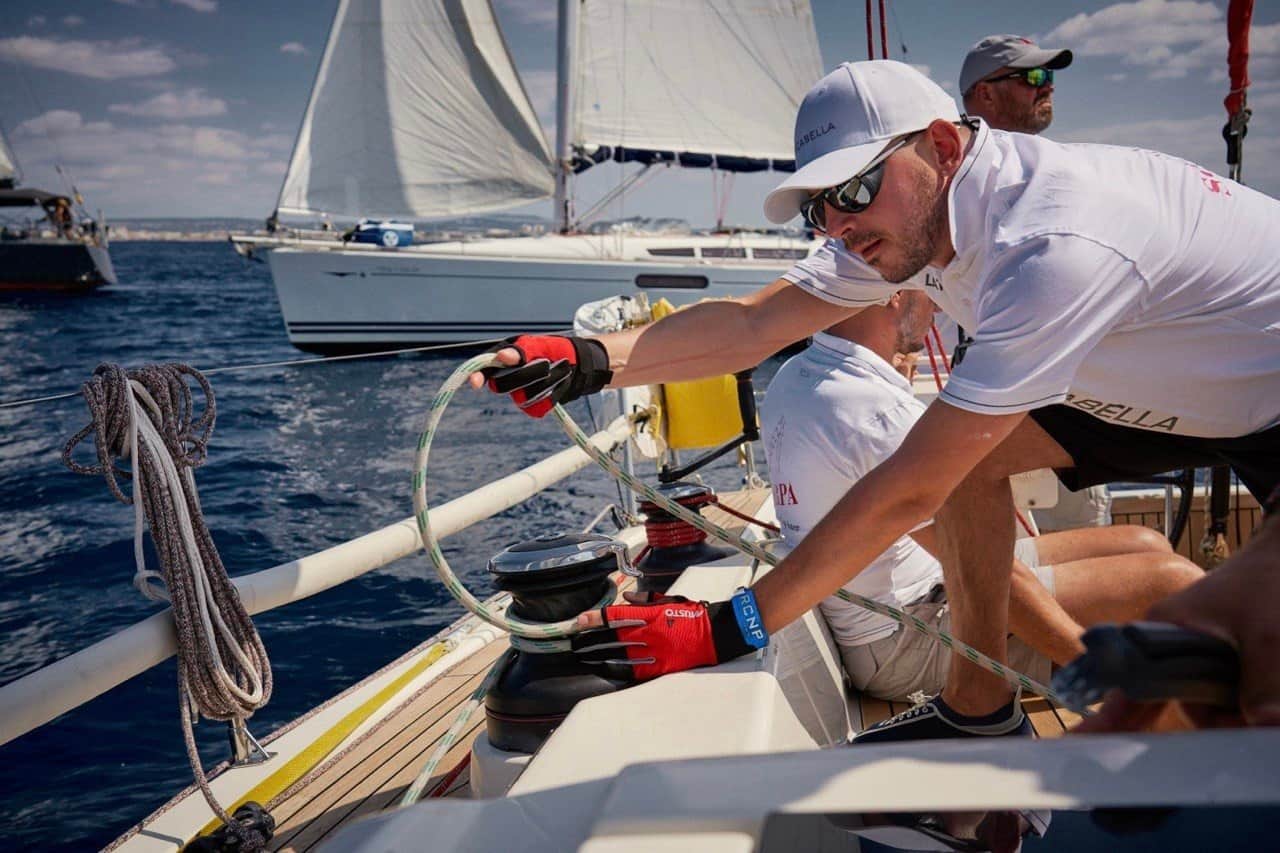 Sailor handling a line at a winch during a yacht race